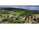 Breathtaking aerial view of a stunning estate with lake views surrounded by lush landscaping and mature trees at 15305 Shady Ln, Tavares, FL 32778