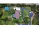 Overhead shot revealing a private pool, circular drive, and lush landscaping surrounding a secluded home at 15305 Shady Ln, Tavares, FL 32778