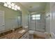 Bathroom features a shower-tub combo and granite countertops at 15305 Shady Ln, Tavares, FL 32778