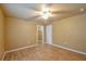 Well-lit bedroom featuring neutral walls, wood floors, and a ceiling fan, creating a cozy atmosphere at 15305 Shady Ln, Tavares, FL 32778