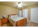 This bedroom features wood flooring, a ceiling fan, and ample closet space with multiple door closets at 15305 Shady Ln, Tavares, FL 32778