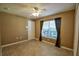 Bedroom features tiled flooring, ceiling fan and a window with blinds at 15305 Shady Ln, Tavares, FL 32778