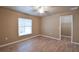 Comfortable bedroom with wood-look floors, ceiling fan, and a walk-in closet, providing ample storage at 15305 Shady Ln, Tavares, FL 32778