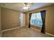 Bedroom features a ceiling fan, window and tile floor at 15305 Shady Ln, Tavares, FL 32778