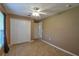 Bedroom with neutral color walls, tiled flooring and large closet at 15305 Shady Ln, Tavares, FL 32778