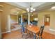 Dining room with wood floors, chandelier, and open access to the living room and kitchen at 15305 Shady Ln, Tavares, FL 32778