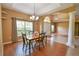 Dining area featuring wood floors, decorative lighting, and large windows at 15305 Shady Ln, Tavares, FL 32778