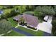 Beautiful exterior view of a single-story home featuring manicured lawn, mature landscaping, and a driveway at 15305 Shady Ln, Tavares, FL 32778