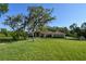 Exterior of a home with mature landscaping and a long private driveway in a rural setting at 15305 Shady Ln, Tavares, FL 32778