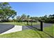 Gated entry to a sprawling estate with mature trees, lush landscaping, and a circular driveway at 15305 Shady Ln, Tavares, FL 32778