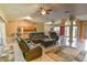 Open-concept living room with tile floors, adjacent to the kitchen and dining area at 15305 Shady Ln, Tavares, FL 32778