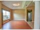 Spacious living room with wood floors, modern ceiling, large window, and decorative column at 15305 Shady Ln, Tavares, FL 32778