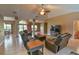 Open-concept living room featuring tile floors, columns, and comfortable furniture at 15305 Shady Ln, Tavares, FL 32778