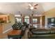 Open-concept living room with tile floors and lots of space for entertaining at 15305 Shady Ln, Tavares, FL 32778