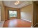 Bright living room featuring wood floors, a large window, and neutral walls at 15305 Shady Ln, Tavares, FL 32778