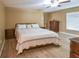 Comfortable main bedroom with wood floors, ceiling fan and neutral colors, creating a peaceful retreat at 15305 Shady Ln, Tavares, FL 32778