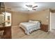 A relaxing main bedroom featuring wood floors, ceiling fan, and neutral walls for a calm and serene atmosphere at 15305 Shady Ln, Tavares, FL 32778