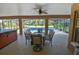 Covered patio features a ceiling fan, outdoor dining table and seating at 15305 Shady Ln, Tavares, FL 32778