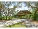 This large parking structure is surrounded by mature trees and shaded by Spanish moss at 15305 Shady Ln, Tavares, FL 32778