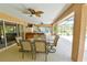 The spacious covered patio includes a ceiling fan, a dining table and a view of the hot tub at 15305 Shady Ln, Tavares, FL 32778