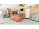 Relaxing covered patio featuring a hot tub, ceiling fans, and outdoor dining area at 15305 Shady Ln, Tavares, FL 32778