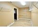 Organized walk-in closet featuring white shelving and wood-look flooring, maximizing storage space at 15305 Shady Ln, Tavares, FL 32778