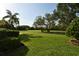 Manicured lawn with mature landscaping and well-maintained hedge in a private residential area at 15305 Shady Ln, Tavares, FL 32778