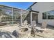 Spacious backyard patio with firepit and serene views of the pool and lush landscaping at 15465 Heron Hideaway Cir, Winter Garden, FL 34787
