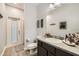 Bright bathroom with a dark vanity, toilet, and tiled floor at 15465 Heron Hideaway Cir, Winter Garden, FL 34787