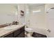 Bathroom featuring tub/shower combo and dark vanity with granite countertop at 15465 Heron Hideaway Cir, Winter Garden, FL 34787
