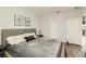 Modern bedroom with neutral tones, wood floors, and bright natural light at 15465 Heron Hideaway Cir, Winter Garden, FL 34787
