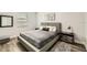 Modern bedroom with neutral tones, wood floors, and natural light at 15465 Heron Hideaway Cir, Winter Garden, FL 34787