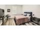 Cozy bedroom featuring hardwood floors, TV, and comfortable furniture at 15465 Heron Hideaway Cir, Winter Garden, FL 34787