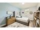 Comfortable bedroom features a tufted headboard, wood floors, soft rug and natural light at 15465 Heron Hideaway Cir, Winter Garden, FL 34787