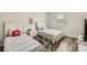 Bedroom with twin beds, wood floors, and large window with coverings at 15465 Heron Hideaway Cir, Winter Garden, FL 34787