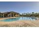 Community pool with plenty of space for lounging, manicured landscaping and lounge seating at 15465 Heron Hideaway Cir, Winter Garden, FL 34787