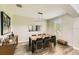 Elegant dining room with modern lighting, a sleek table, and chic decor for sophisticated gatherings at 15465 Heron Hideaway Cir, Winter Garden, FL 34787