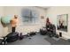 Well-equipped home gym with heavy bag, exercise equipment, and padded flooring at 15465 Heron Hideaway Cir, Winter Garden, FL 34787