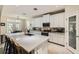 Bright kitchen with white cabinetry, stainless steel appliances, a large center island, and sleek countertops at 15465 Heron Hideaway Cir, Winter Garden, FL 34787