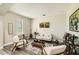 Cozy living room featuring stylish decor, comfortable seating, and elegant wood-look tile flooring at 15465 Heron Hideaway Cir, Winter Garden, FL 34787