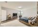 Bright bedroom featuring wood floors, large windows, and a media center at 15465 Heron Hideaway Cir, Winter Garden, FL 34787