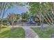 Safe and fun playground with slides and play structures, surrounded by lush trees and landscaping at 15465 Heron Hideaway Cir, Winter Garden, FL 34787