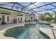 Private pool with a screened-in lanai and spacious covered patio with an outdoor kitchen at 15465 Heron Hideaway Cir, Winter Garden, FL 34787