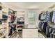 Organized walk-in closet with shelving, hanging rods, and a center island at 15465 Heron Hideaway Cir, Winter Garden, FL 34787