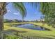Well-maintained backyard with a serene water view, mature landscaping and secure fence at 15465 Heron Hideaway Cir, Winter Garden, FL 34787