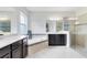 Luxurious bathroom with a soaking tub, dual vanities, and a separate glass-enclosed shower at 15485 Sandfield Loop, Winter Garden, FL 34787