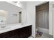 Bright bathroom featuring double sinks, a large mirror, and a separate water closet and shower/tub combo at 15485 Sandfield Loop, Winter Garden, FL 34787