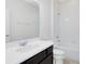 Clean bathroom featuring a single vanity, a toilet, and a shower with a tub, all in a simple design at 15485 Sandfield Loop, Winter Garden, FL 34787