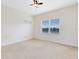Bright bedroom featuring a neutral color scheme, plush carpeting, and a window with natural light at 15485 Sandfield Loop, Winter Garden, FL 34787