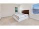 Cozy bedroom featuring a comfortable bed, neutral carpeting, and a window allowing natural light at 15485 Sandfield Loop, Winter Garden, FL 34787